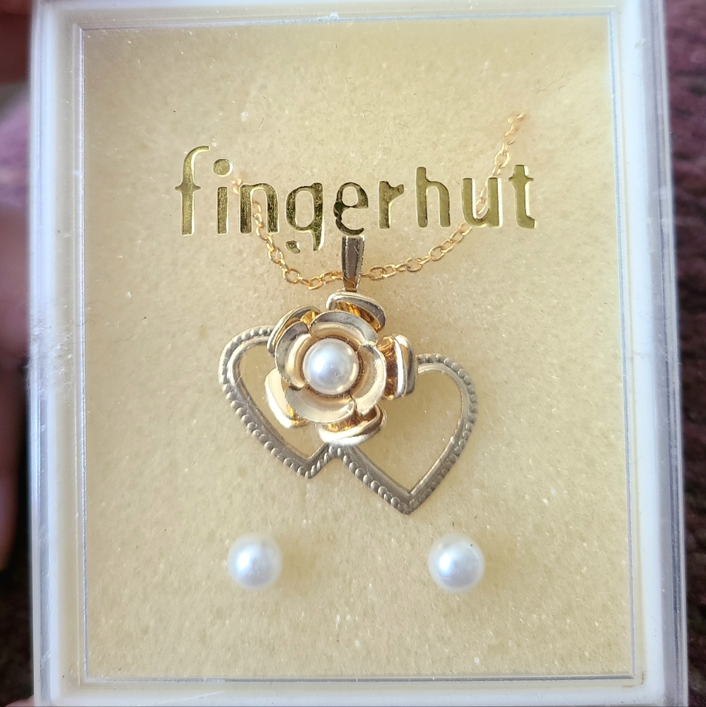 New in box, pearl and goldtone flower and heart necklace and earrings set.